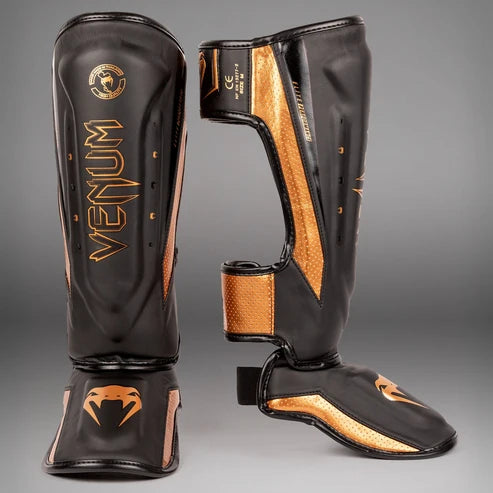 Espinilleras Venum Elite Evo  - Negro/Bronce