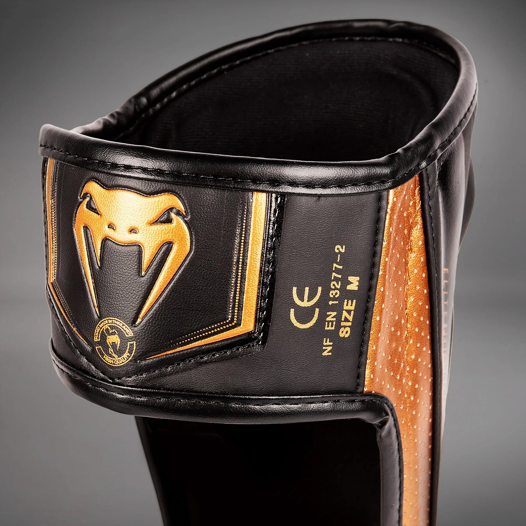Espinilleras Venum Elite Evo  - Negro/Bronce