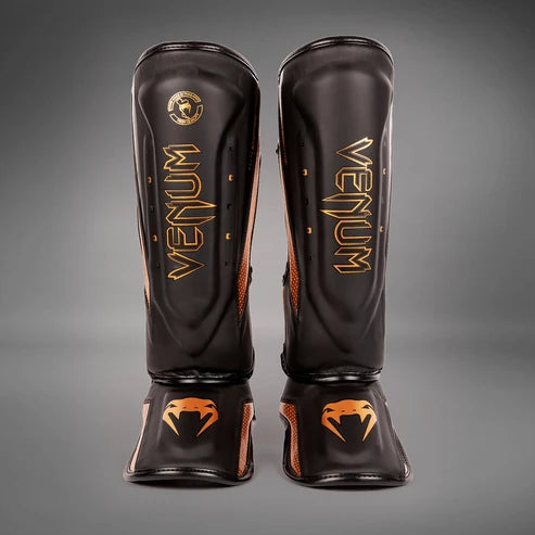 Espinilleras Venum Elite Evo  - Negro/Bronce
